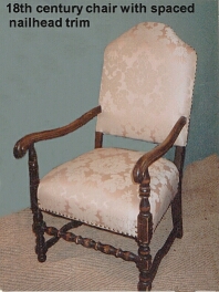 Damask covered armchair with nailhead trim